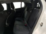the back seats of a white car with a black seat belt