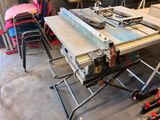 a table that has a saw on it in a garage