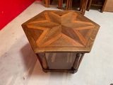a small wooden table with a star design on it