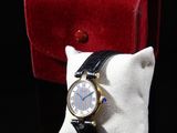 a watch that is sitting on top of a pillow
