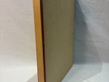 an old book sitting on top of a white table next to a white sheet