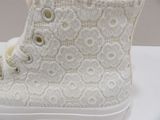 a close up of a pair of white shoes on a table