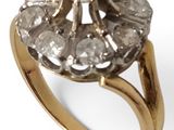 an image of a gold ring with a cluster of diamonds on it