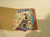 a picture of a book with stamps on it and a shadow of a person