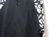 a black jacket with white letters on it hanging on a hanger