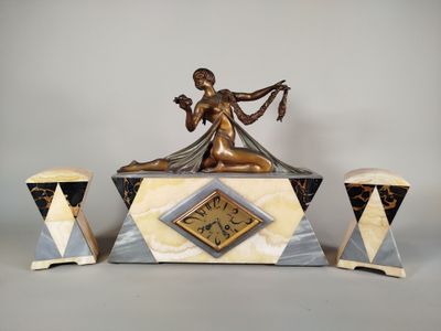 a statue of a woman sitting on top of a clock