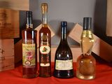 several bottles of wine are lined up on a red table