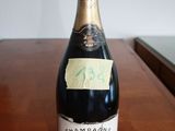 a bottle of champagne sitting on a table with a sticker on it