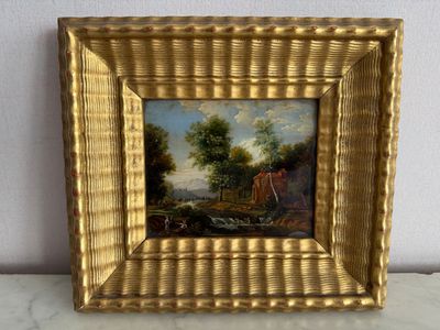 cadre doré avec un tableau représentant un homme et une femme dans un paysage