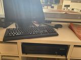 a computer desk with a keyboard and a monitor on it