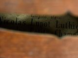 a close up of a piece of wood with writing on it