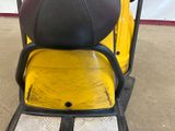 a yellow scooter with a black seat in a garage