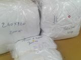 three bags of white toilet paper sitting on top of a cardboard box