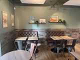 tables and chairs in the corner of a restaurant