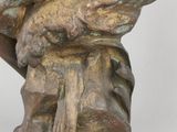 bronze statue of a man holding a bird on a white background