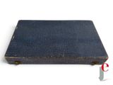 an old blue book sitting on top of a white surface