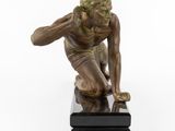 statue of a man crouching on a marble base