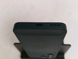the back of a black cell phone sitting on top of a white surface