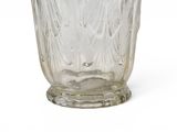 a glass vase that is sitting on a white surface