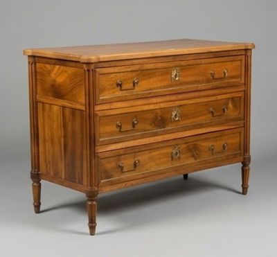 an antique chest of drawers with a wooden top