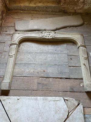 a fireplace in the corner of a room that is being remodeled