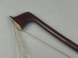 a wooden stick with a long blade on a white surface