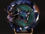 a picture of a blue and green plate with a dragon on it