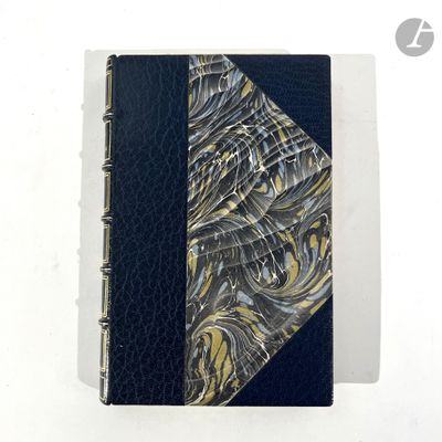 leather bound notebook with a black cover and a gold and silver swirl design