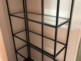 a glass shelf in the corner of a room