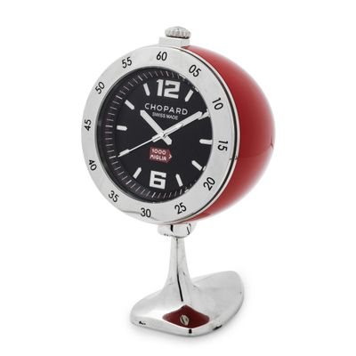 an image of a red and black clock on a stand