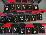 a lot of necklaces and earrings on display in a box