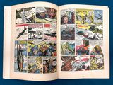 an open comic book on a blue surface with a comic strip