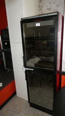 an image of a refrigerator in a kitchen with a glass door