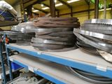 many different types of belts on a shelf in a warehouse