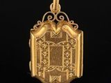 a gold locke with an ornate design on the front