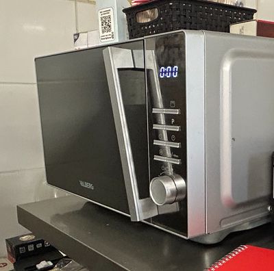 a microwave sitting on top of a shelf in a kitchen