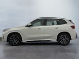 the bmw x1 is parked on a concrete surface