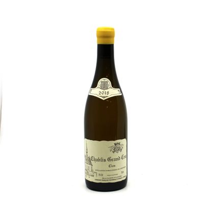 a bottle of wine sitting next to a glass of wine