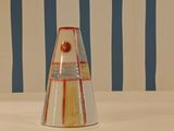 a vase that is sitting on a table in front of a striped wall