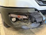 the front bumper of a car with a damaged bumper and a damaged bumper