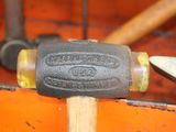 a close up of a hammer on a piece of wood