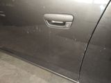 a car door handle with a small hole in it