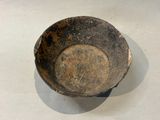 a dirty bowl sitting on a table with a white table cloth