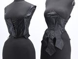two black mannequins with black leather bows on them