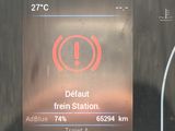 dashboard of a car with a warning sign on the display