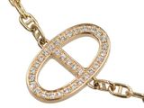 a close up of a gold necklace with diamonds on a chain