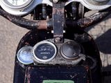 a close up of a motorcycle with a clock on it ' s handlebar