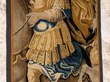 a tapestry with a picture of a man riding a horse