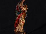 a statue of the virgin of guadalupe with a crown on her head