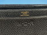 a black leather wallet with a gold logo on the front